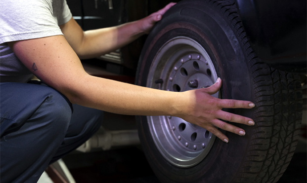 Fitter checking a tyre
